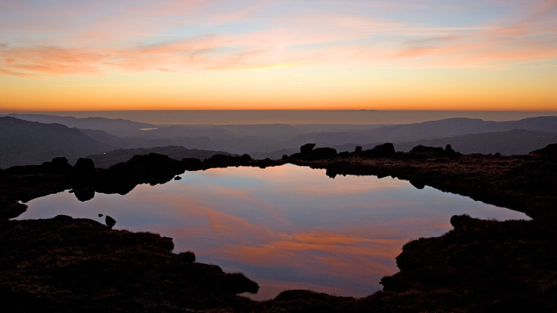 Reflected sunset in tarn on Little Stand